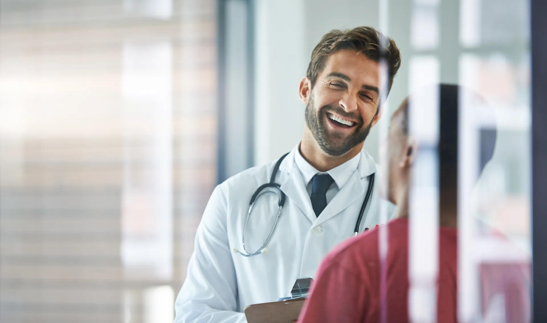 A practice owner greeting a new patient who found him online